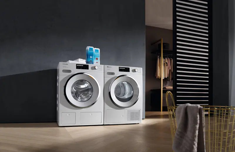 Miele 24" Ventless Condensing Electric Dryer with 4.02 Cu. Ft. Capacity next to matching washer